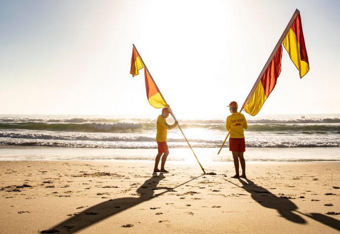Lifesavers putting up the red and yellow flags