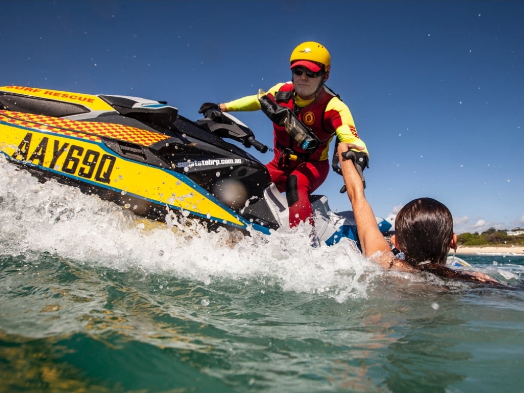 Lifesaver on a jet ski rescuing someone