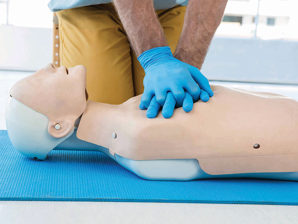 Person performing CPR on a manikin