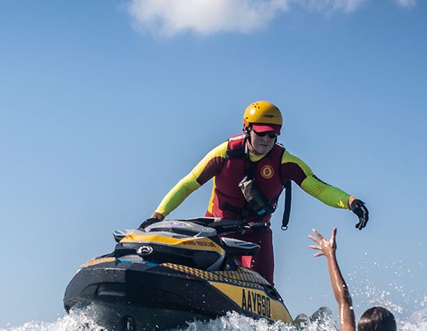 Lifesaver on a jetski rescuing someone