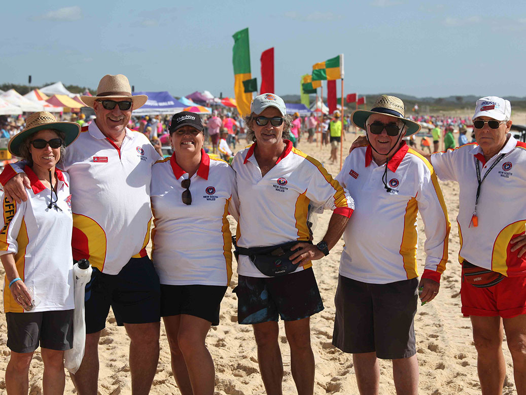 Officials standing on the beach