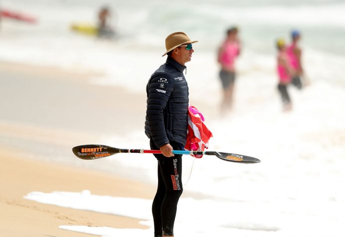 Coach on the beach watching competiton