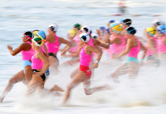 Athletes running into the water