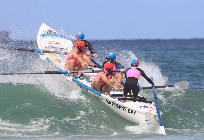 Surf boat crew competing