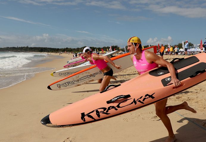 Athletes running into the water